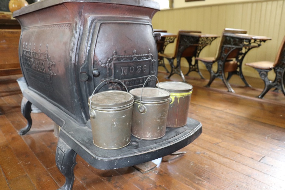 The lunch pails, which were used to warm food in the winter, at the Little Stone Schoolhouse today.